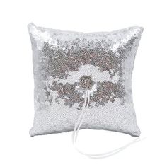 a pillow with sequins on it and a white cord in the back ground