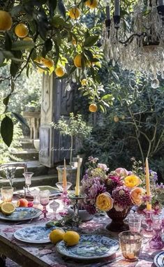 the table is set with lemons, plates and glasses for dinner guests to enjoy