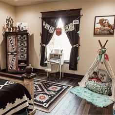 a bedroom decorated in native american style with teepee tent bedding and rugs