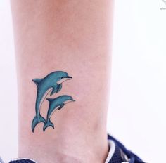 a small dolphin tattoo on the ankle