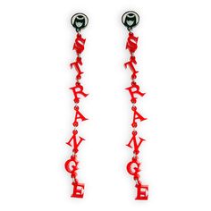 Get strangely dramatic with our lengthy Officially Licensed Emily the Strange® Stay Strange Dangle Earrings. Red acrylic dangly letters hang on a glow-in-the-dark Emily logo charm. Strange strand is approximately 5" in shoulder-grazing length. We finish these earrings off with nickel free surgical steel studs. Nickel free surgical steel Plastic solid red material Sold as a pair Glow-in-the-dark base Red Gothic Earrings For Pierced Ears, Novelty Red Plastic Jewelry, Red Gothic Earrings, Whimsical Red Nickel-free Earrings, Emily Strange, Gothic Red Nickel-free Earrings, Pop Art Pet Portraits, Emily The Strange, Solid Red