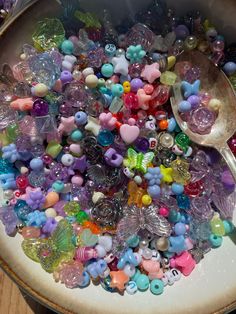 a bowl filled with lots of different colored beads