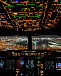 an airplane cockpit with two screens showing the flight path and landing lights at night time