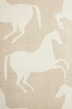 a white horse on a beige background that is very similar to the wallpaper in this room