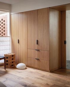 a bedroom with wooden furniture and white walls