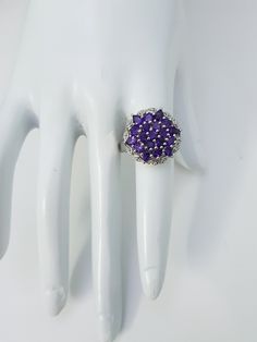 This Natural Amethyst Ring is made with thirteen round and six pear shape beautiful small amethyst Gemstones Cased in 92.5 Sterling Silver material. Gemstone : Natural Amethyst Ring weight : 6.73 grams Metal type : 925 Sterling silver Gemstones Shape :13 Round,6 Pear Gemstones Size : 3 mm Round ,3x4 mm Pear Gemstones count :19 Stones ⦿ Payment Policy :- We accept payment through PayPal. ⦿ Shipping Policy :- * All Items will Be Carefully packed and Shipped Through UPS, Aramex, DHL eCommerce, Indi Amethyst Cluster Gemstone Jewelry, Purple Crystal Ring With Halo Setting, Silver Multi-stone Cluster Ring, Sterling Silver Cluster Ring With Prong Setting, Round Sterling Silver Amethyst Ring, Anniversary Cluster Ring With Stones, Cluster Amethyst Gemstone Rings, Purple Round Multi-stone Jewelry, Purple Amethyst Cluster Ring With Gemstone