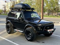 a black suv parked in a parking lot with its roof rack on it's flatbed