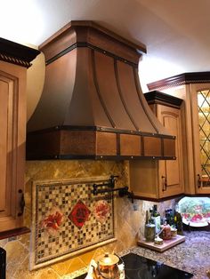 a stove top oven sitting inside of a kitchen next to wooden cabinets and counter tops