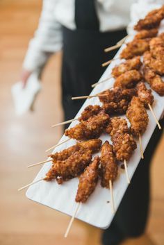 there are skewers of food on the table ready to be served for guests