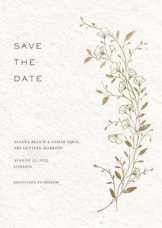 a white and gold wedding save the date card with flowers on it's side