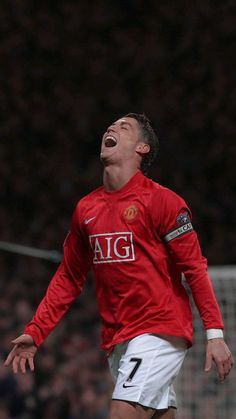 a man in red shirt and white shorts playing soccer