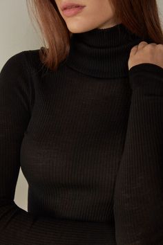 Long-sleeve high-neck tubular top made from a wool-silk blend. Sleek Fitted Winter Tops, Sleek Fitted Top For Winter, Sleek Fitted Tops For Winter, Elegant High Neck Winter Tops, Elegant High Neck Tops For Winter, Sleek Winter Turtleneck, Elegant Winter Fitted Turtleneck, Elegant Fitted Winter Turtleneck, Elegant Fitted Turtleneck For Winter