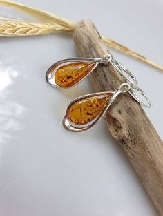 Welcome to my handmade shop. Item description: Sterling silver 925 earrings with Amber and all hallmarks. Length: 5 cm This item was made of natural Baltic Amber. All the amber used in my jewelry is collected in my home country Lithuania. I sell only genuine, real, not pressed, authentic, natural Baltic Amber. Item may have natural imperfections. Due to amber being natural, each of my jewelry is unique and even the same models can be slightly different. Please contact me for more details, photos Elegant Amber Sterling Silver Earrings, Classic Amber Earrings For Gift, Amber Sterling Silver Dangle Earrings, Classic Amber Sterling Silver Earrings, Amber Sterling Silver Earrings, Gift Amber Drop Earrings, Amber Dangle Earrings For Anniversary, Hypoallergenic Amber Sterling Silver Earrings, Amber Sterling Silver Hypoallergenic Earrings