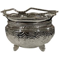 an ornate silver bowl with handles