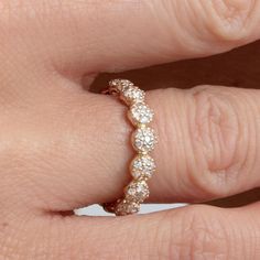 a woman's hand with a diamond ring on it