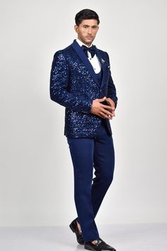 Blue tuxedo with bead embroidery details. Paired with a waistcoat with a sequin embroidered flap, shirt, pant and bow.
Components: 5
Pattern: Embroidered
Type Of Work: Sequin
Neckline: Lapel collar
Sleeve Type: Long
Fabric: Crepe, Handloom Silk, Terry Rayon
Color: Blue
Other Details: 
Note: Brooch and pocket square shown in the image is not for sale.
Occasion: Cocktail and Reception - Aza Fashions Custom Fit Notch Lapel Blazer For Party, Tailored Blue Outerwear For Party, Blue Formal Sets For Winter, Luxury Fitted Suit For Festive Season, Fitted Royal Blue Blazer For Wedding, Royal Blue Fitted Blazer For Wedding, Blue Formal Winter Sets, Tailored Three-piece Suit With Long Sleeves For Party, Blue Slim Fit Tuxedo For Wedding