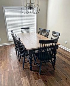 a dining room table with chairs and a chandelier