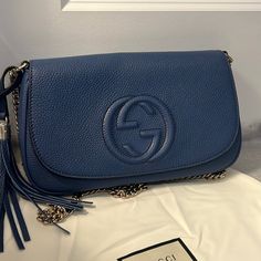 Never Worn. Description: Brand New Authentic Gucci Soho Leather Chain Crossbody Bag, Black Brand: Gucci Includes Dust Bag Color: Blue Leather Embossed Interlocking G Chain Strap With 20.5" Drop Leather Tassel Light Gold Tone Hardware One Interior Open Pocket One Interior Zip Pocket Made In Italy Flap With Magnetic Closure Approx. Dimensions: 10.6" L X 2" D X 6" H Blue Gucci Shoulder Bag With Detachable Strap, Gucci Blue Shoulder Bag With Detachable Strap, Blue Gucci Crossbody Shoulder Bag, Blue Gucci Shoulder Bag For Formal Occasions, Formal Blue Gucci Shoulder Bag, Blue Gucci Shoulder Bag For Evening, Blue Gucci Evening Shoulder Bag, Blue Gucci Bag For Formal Occasions, Formal Blue Gucci Bag