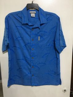 Beautiful preowned lightly worn button up camp shirt River Lodge Columbia edition. No defects, perfect Measurements pit to pit 21 1/2” shoulder to hem 30” Blue Summer Camp Shirt With Pockets, Blue Camp Shirt With Pockets For Summer, Blue Short Sleeve Shirt With Camp Collar For Beach, Blue Camp Shirt With Pockets For Beach, Casual Blue Camp Collar Short Sleeve Shirt, Casual Blue Hawaiian Shirt With Short Sleeves, Blue Casual Hawaiian Shirt With Short Sleeves, Blue Hawaiian Short Sleeve Cotton Shirt, Casual Blue Short Sleeve Shirt With Camp Collar