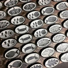 several plates with different designs on them sitting on top of a wooden table next to each other