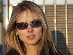 a woman wearing sunglasses and looking at the camera