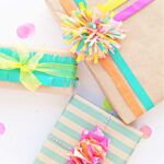 three wrapped presents with ribbons and bows on them