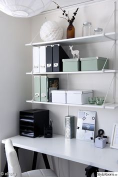 a white desk topped with shelves filled with office supplies