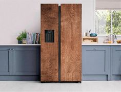 a wooden refrigerator freezer sitting inside of a kitchen