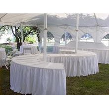 several tables and chairs under a white tent