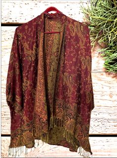 Paisley Pashmina Kimonos | dark Red / Burgundy A fantastic way to stay both stylish and warm. Say goodbye to the struggle of keeping a scarf in place and hello to a chic and comfortable alternative. The free-size kimono offers a fashionable solution to stay comfortable while effortlessly maintaining your style.  Handmade from a delightful and soft pashmina fabric. Features a bohemian style oversized and flowing design. Styled like a cardigan with an open front and generous sleeves . The front is Luxury Multicolor Pashmina Shawl With Pallu, Luxury Bohemian Pink Shawl, Vintage Fall Shawl, Red Bohemian Kimono For Fall, Bohemian Brown Kimono For Fall, Red Kimono For Fall, Red One-size Kimono For Fall, One Size Red Kimono For Fall, Red Bohemian Shawl Outerwear