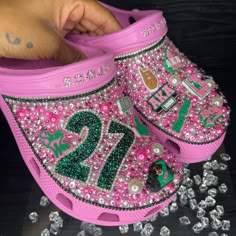 Elevate Your Style With These Personalized Aka Crocs, Adorned With Charms, Rhinestones, And Proudly Displaying Your Line Number. Celebrate Sisterhood In Every Step With This Unique Touch Of Elegance. Stride With Pride In These One-Of-A-Kind Crocs, A Perfect Blend Of Comfort, Style, And Individuality. For Alternative Sorority Options And To Customize Your Order, Please Email Or Dm Us Your Order Number, Line Number And Any Other Customizations. #Akastyle Email: Info@Artistrybynita.Com Ig: @Aartist Camo Bling Crocs, Bedazzled Cow Print Crocs, Crocs Charms Chanel, Alpha Kappa Alpha Sorority Wallpaper, Crocs With Rainbow Charms, Junk Crocs, Aka Crocs, Aka Decorations, Croc Design Ideas