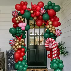 the front door is decorated with balloons and candy canes