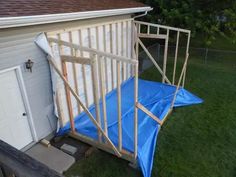 a blue tarp on the side of a house