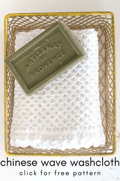 a white crocheted dishcloth with a tag on it and the words, chinese wave wash cloths click for free pattern