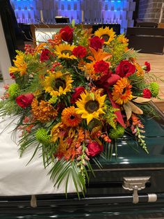 a bouquet of flowers sitting on top of a piano