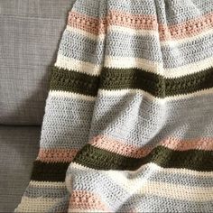 a crocheted blanket sitting on top of a couch