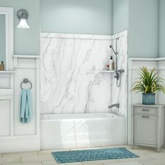 a bath room with a sink and a bath tub next to a mirror on the wall