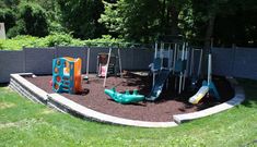 an outdoor play area with swings, slides and climbing equipment in the middle of it