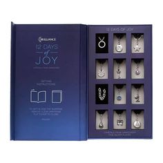 the twelve days of joy book is open to reveal its contents and features various necklaces