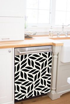 a black and white pattern on the side of a dishwasher in a kitchen