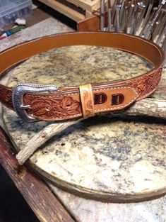 Custom hand tooled Floral design , monogrammed belts dyed Sheridan Brown , made from 8-9 ounce top grain leather , lined , Comes with Silver engraved buckle . Please see above diagram on measuring for your belt size . These are all lockstitch sewn and will last for years . Please include size and letters for monogramming . **Please allow 8-10 days for shipment Hand Tooled Leather Belt Buckles For Rodeo, Western Style Engraved Leather Belt, Engraved Leather Western Belt, Western Leather Embossed Belt Buckles, Western Engraved Adjustable Belt, Western Style Engraved Adjustable Belts, Western Adjustable Engraved Belts, Western Style Adjustable Engraved Belts, Classic Adjustable Hand Tooled Belt