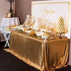 a table covered in gold sequins and desserts