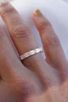 a woman's hand with a diamond ring on it