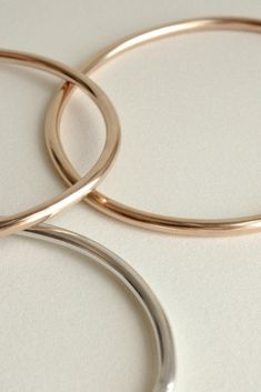 The Georgia is a timeless, minimalist bracelet style with an organic oval shape designed for constant wear. It is comfortable enough to wear even while sleeping, yet strong enough to gracefully withstand years of daily use. Each hand-soldered bracelet is shaped to mimic the contours of your forearm. Available in durable 14k gold fill, solid sterling silver, and solid 14k gold. These materials are water resistant and low maintenance. For more information, visit our Metals Encyclopedia. ✦ SIZING ( Modern Flexible Round Bangle, Modern Round Cuff Bracelet With Shiny Finish, Elegant Everyday Bracelets With Round Band, Modern Shiny Round Cuff Bracelet, Minimalist Polished Bangle, Elegant Everyday Round Band Bracelets, Modern Rose Gold Jewelry With Smooth Bezel, Minimalist Rounded Jewelry With Shiny Finish, Elegant Everyday Round Band Bracelet