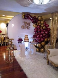 a table with balloons and cake on it in front of a backdrop that says mr and mrs quince