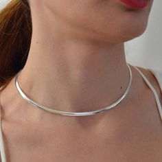 Very good quality sterling silver .925 smooth shiny finish Omega chokers, stylish and trendy. Five different styles to choose from. Choose a desired color and a style by a number from the drop down, SIZES Choker size in flat style 4 mm x 16'' numbers ( 1,2, and 3) Choker size in round style 2 mm x 16'' numbers ( 4 and 5) COLORS Sterling silver. Gold over silver Rose gold color (#4 only) Good gift for: Mother's day. Birthday, Anniversary Graduation Perfect for work & everyday style for the la Trendy Silver Snake Chain Choker, Snake Chain Necklace Choker For Gift, Snake Chain Choker Necklace Perfect For Gifts, Minimalist Snake Chain Choker Necklace, Herringbone Choker Necklace For Gift, Gift Herringbone Choker Necklace, Trendy Silver Herringbone Snake Chain Necklace, Silver Herringbone Necklace With Snake Chain, Trendy Silver Herringbone Necklace