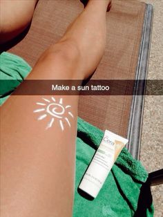 the sun tattoo is on someone's arm next to a bottle of sunscreen