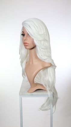 **View the Prudence style in all available colors!** Wig Type: Lace Front Lace Type: High-quality Swiss lace Special Features: Yaki texture Color: White Length: Approximately 28"-32" long Style: Extra-long, straight, w/ side swept bangs Parting: Permanent side lace part, also known as a c-part Heat Resistance: Up to 340°F Hair Density/Thickness: 100% Cap Size: Approx. 23" head sizes best Internal Structure: Metal combs + elastic for custom fit Series: Natural Please click here for all the detail White Lace Front Wig, Swept Bangs, Side Swept Bangs, Side Swept, Texture Color, Hair Density, Swiss Lace, Long Style, Winter White