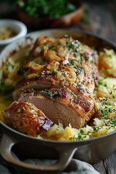 Roasted pork loin topped with herbs and served on a bed of vegetables in a baking dish. Pork Tenderloin With Sauerkraut, Pork And Sauerkraut Recipe, Pork Roast And Sauerkraut, Oven Roasted Pork Tenderloin, Masakan Simple, Pork And Sauerkraut, Pork Scallopini, Oven Roasted Pork, Roasted Pork Tenderloin