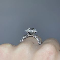 a woman's hand with a diamond ring on it